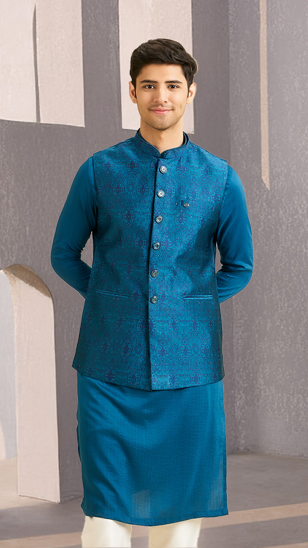 Man sporting a classic blue Nehru jacket, a timeless and elegant outfit for wedding celebrations.